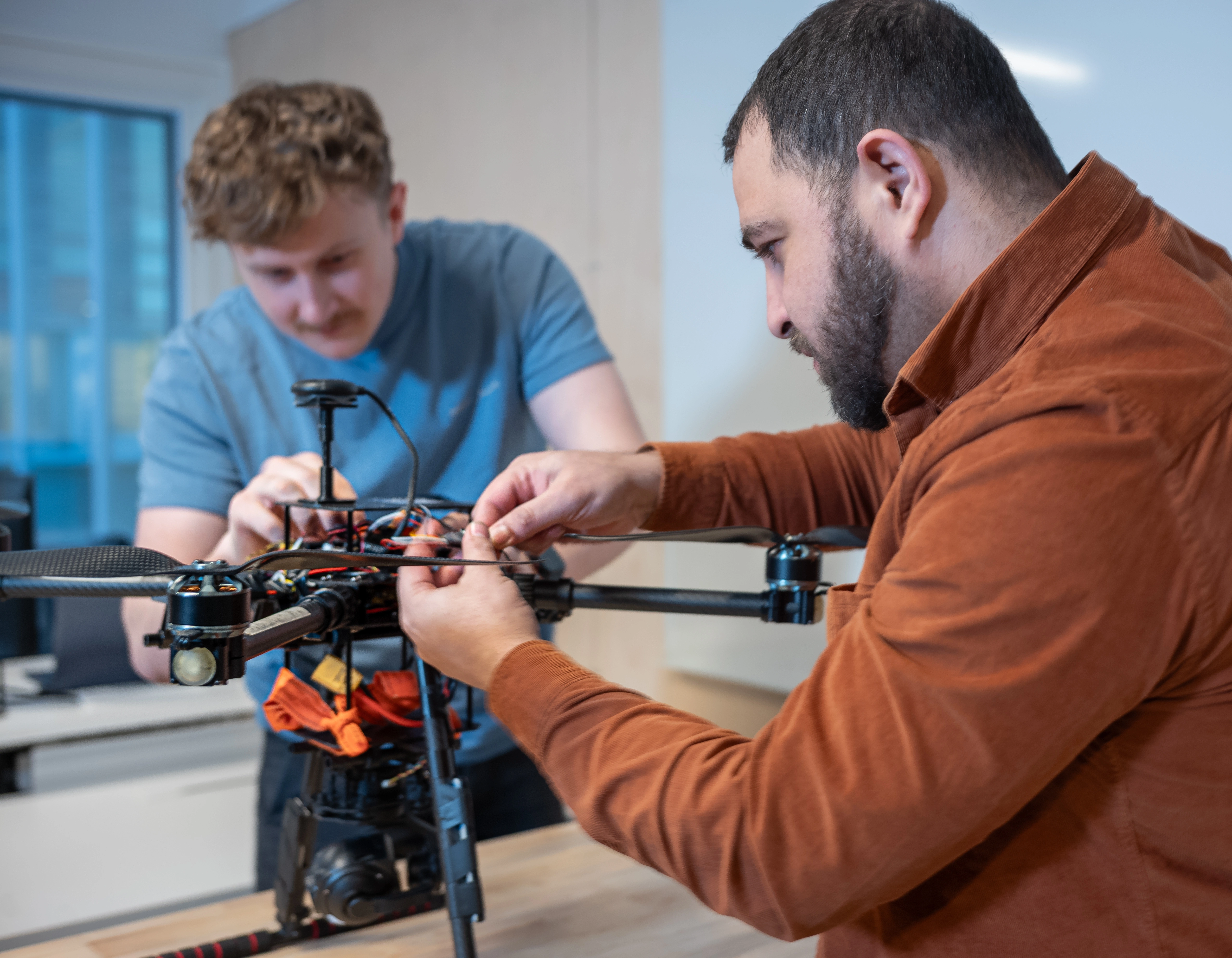 Two Birdview team members working on a UAV in the workshop